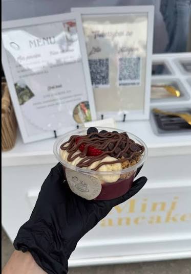 Açaí bowl cup topped with granola and fresh fruit