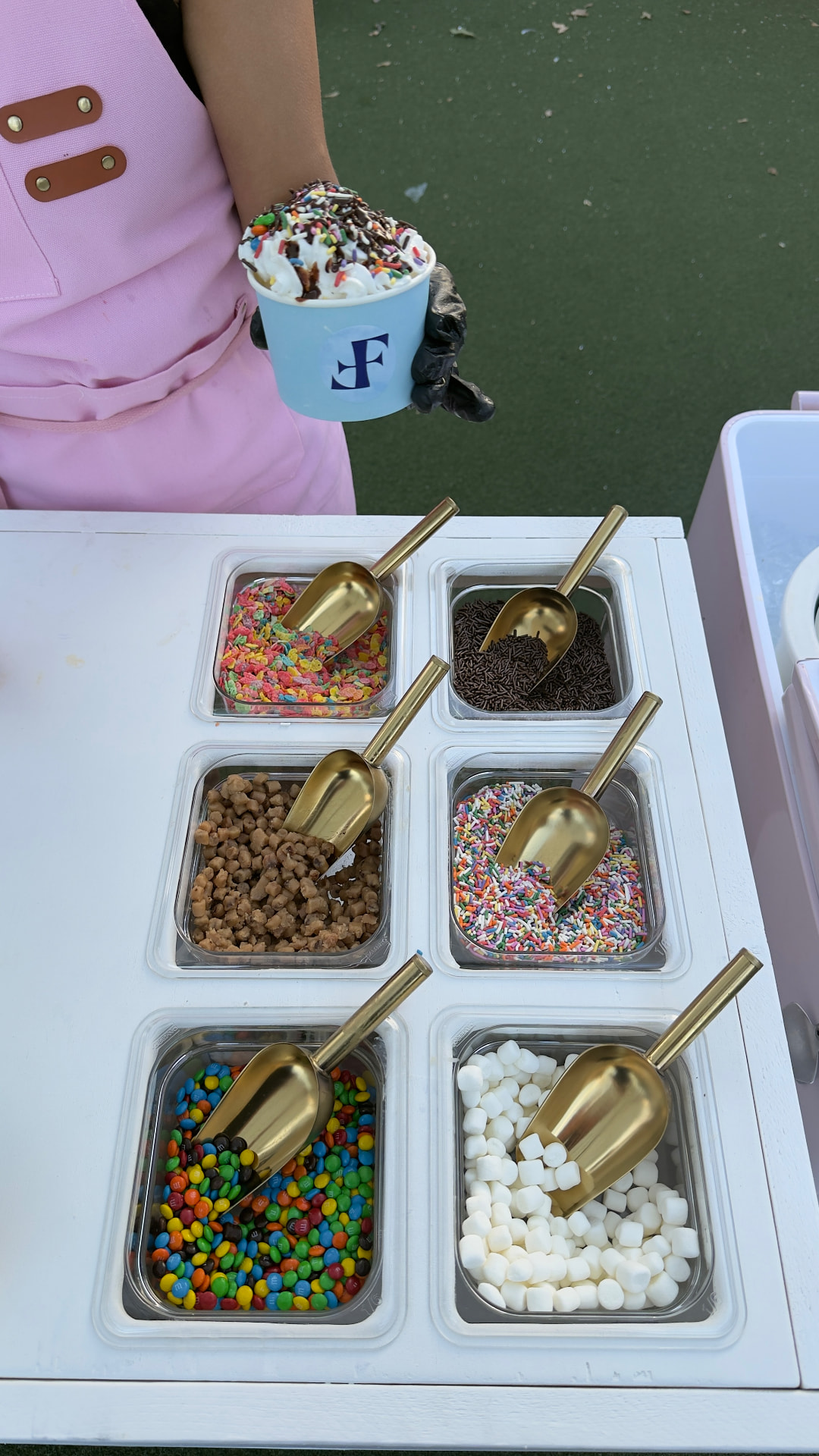 Topping trays filled with candies, sprinkles and fresh fruit