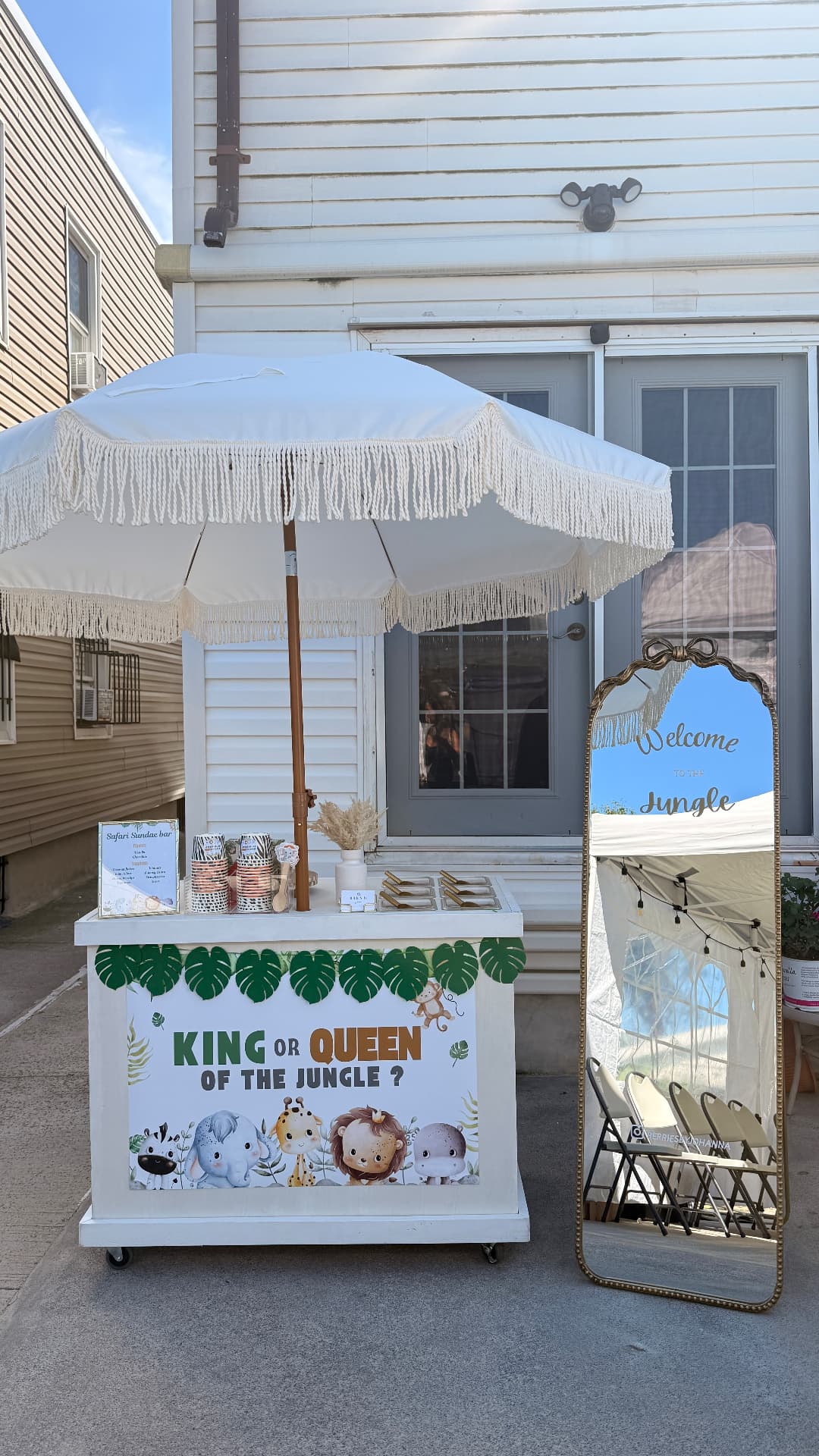 Custom jungle-themed dessert cart with 'King or Queen of the Jungle' signage and welcome mirror